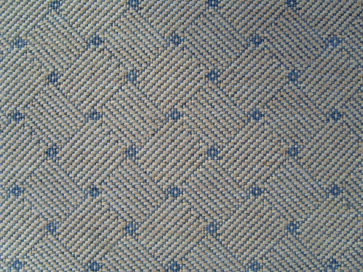 Close-up of an intricate blue and ivory woven textile